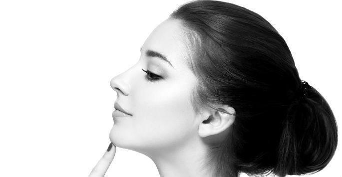 woman in profile touching her chin