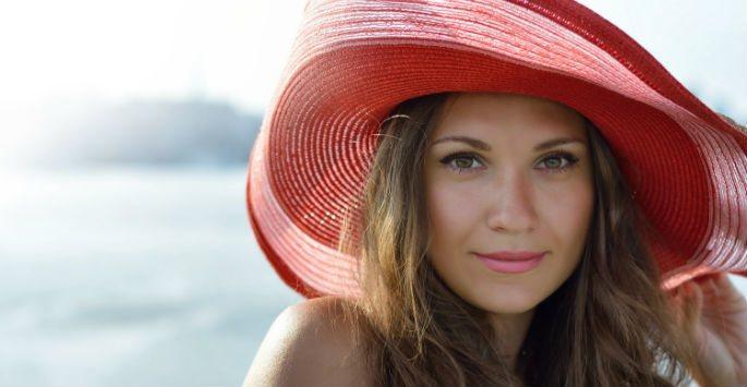 woman wearing hat by the ocean