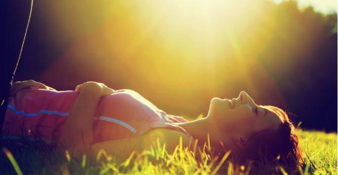 woman lying on the ground and laughing