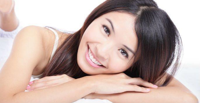 woman lying on bed and smiling