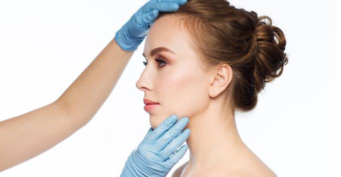 dermatologist checking woman's skin