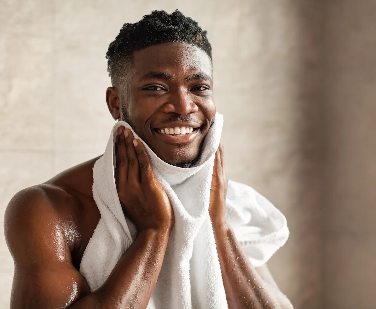 young man washing his face to prevent acne