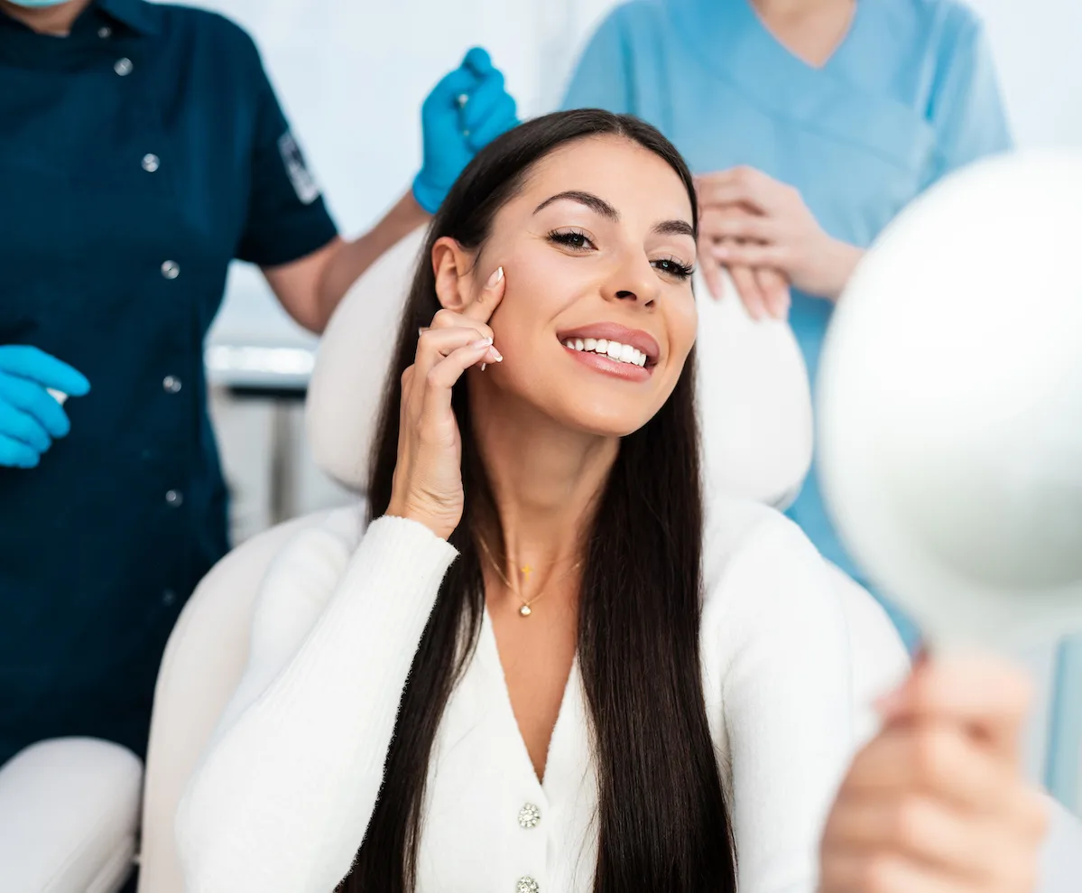 patient looking in mirror after injectable filler procedure