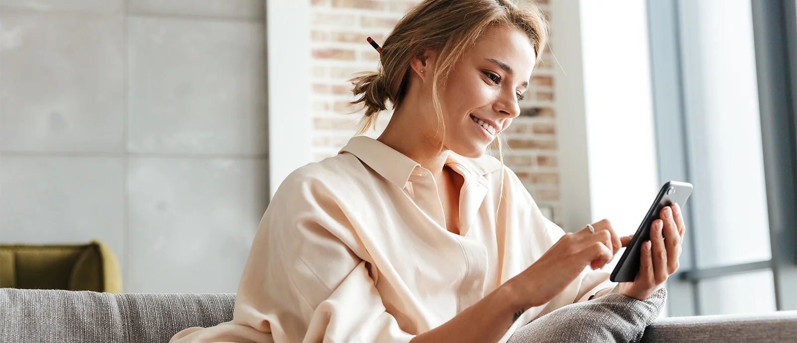 beautiful young woman using her phone to redeem aesthetic rewards