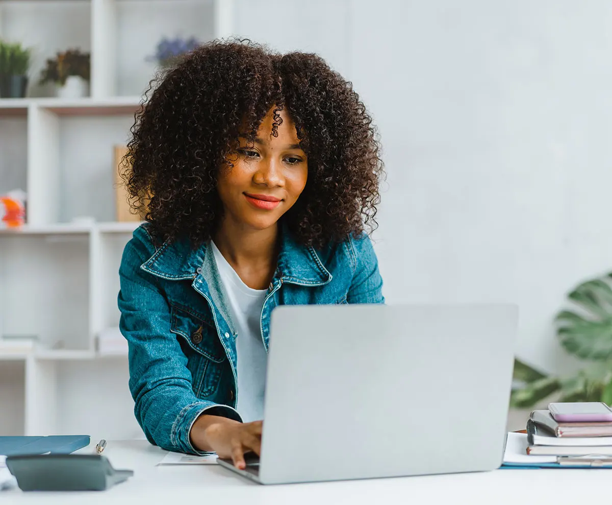 woman on laptop reading about insurance and financing